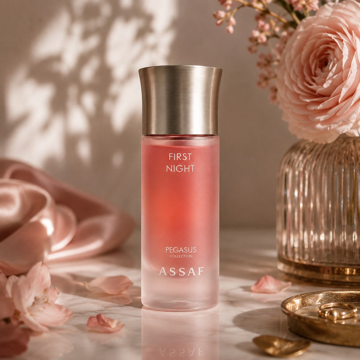 Soghaat First Night Eau de Parfum, a sweet amber gourmand fragrance in a frosted pink bottle with a metallic cap.