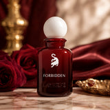 Soghaat Forbidden Eau de Parfum for women in a deep red glass bottle with a white spherical cap. Notes of marshmallow, cherry, rose, amber, and musk.