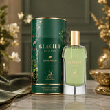 Soghaat Maison Alhambra Glacier Heaven unisex Eau de Parfum bottle and green floral canister on a marble table.
