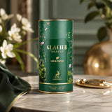 Soghaat Maison Alhambra Glacier Heaven 100ml Eau de Parfum in a cylindrical green bottle with gold accents.