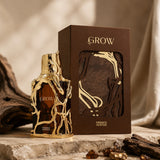 Soghaat Grow 100ml Extrait de Parfum bottle with ornate gold branches and brown box. Amber woody oriental fragrance.