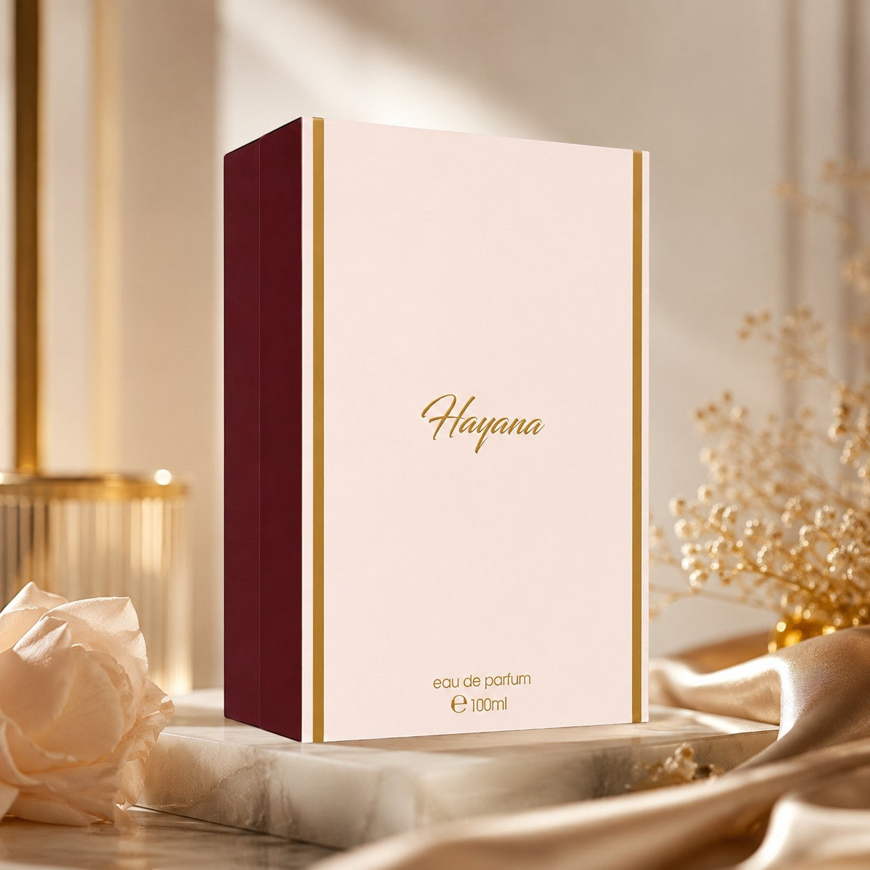 Soghaat Hayana Eau de Parfum by Ahmed Al Maghribi in a pale pink and burgundy box with gold lettering on a marble base