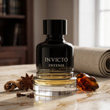 Soghaat Invicto Intense Eau de Parfum for men in a sleek black bottle with amber and spice accents on a marble table.