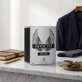 Soghaat Invicto Intense 100ml Eau de Parfum box featuring wing graphics on a marble desk with a suit jacket background