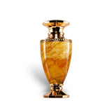 Soghaat Jade Giallo Extrait de Parfum bottle with a marbled amber body and gold accents. Fresh woody aromatic fragrance.