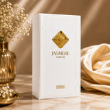 Soghaat Jasmere Extrait de Parfum by French Avenue in a white box with gold emblem on a marble surface with flowers.