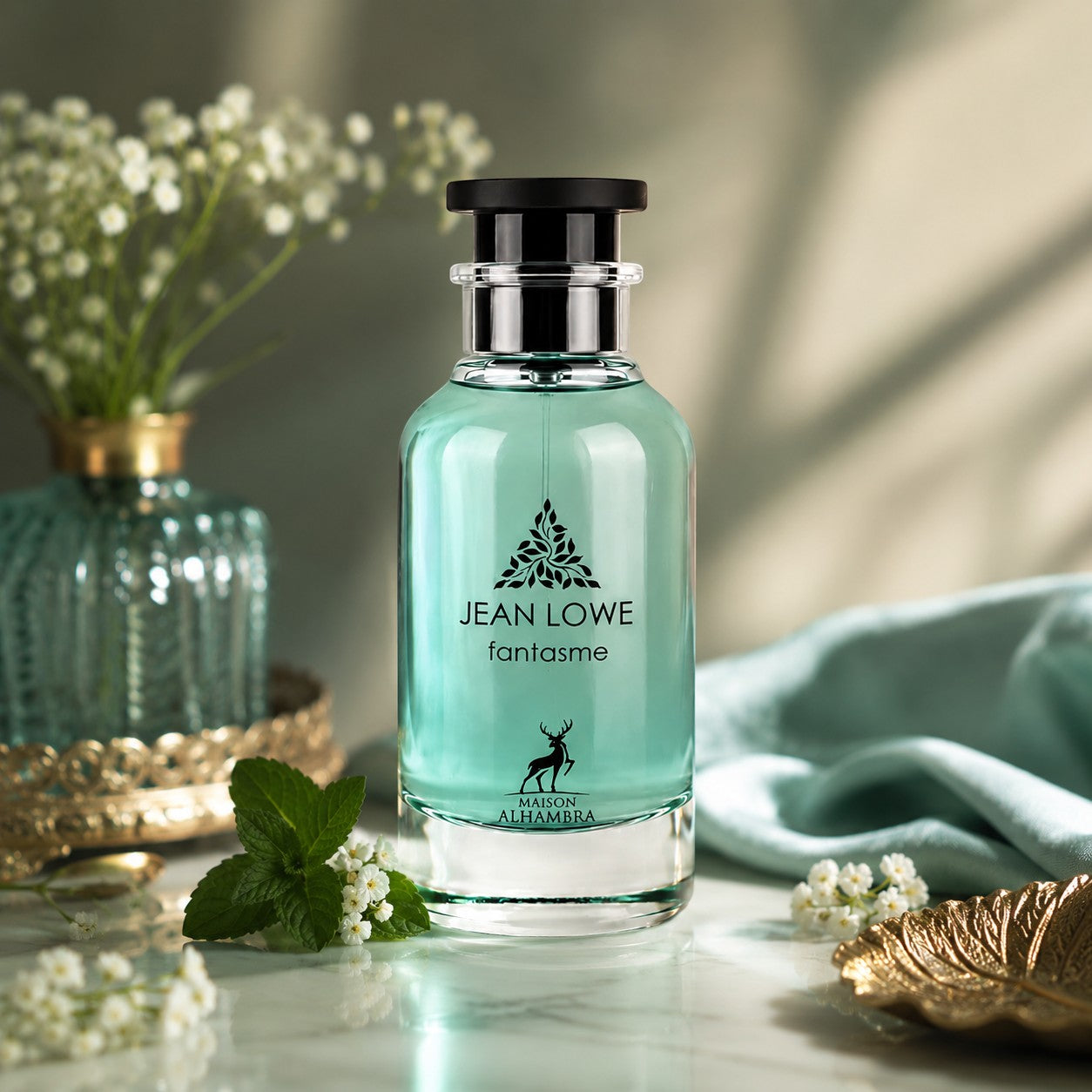 Soghaat Jean Lowe Fantasme Eau de Parfum bottle with light blue liquid, displayed on a marble surface with flowers.
