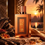 Soghaat Kayaan Terra Eau de Parfum bottle in metallic bronze, set against a sunset desert backdrop with resin and wood.