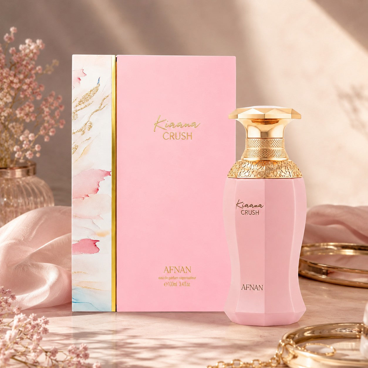 Soghaat presents Afnan Kiaana Crush Eau de Parfum in a pink bottle and box with gold accents, featuring amber oud notes.
