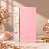 Soghaat Kiaana Crush Eau de Parfum by Afnan in a pink box with marble-style side panel, displayed on a marble table.
