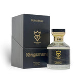 Soghaat Kingsman Extrait de Parfum by Bujairami, a 100ml bottle with a black leather-like band and gold accents, next to its black presentation box.