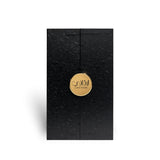 Soghaat Ahmed Al Maghribi Laathani Eau de Parfum black textured presentation box with a gold circular logo emblem.