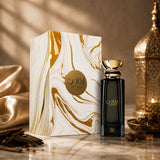 Soghaat Laathani Eau de Parfum by Ahmed Al Maghribi in a black bottle with gold accents next to its marble-patterned box.