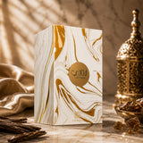 Soghaat Laathani Eau de Parfum box with white and gold marble pattern, featuring oud and amber accents on a table.