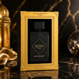 Soghaat Lattafa Badee Al Oud Black Exposed unisex Eau de Parfum in a black and gold presentation box on marble.