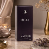 Soghaat presents Laverne Bella 100ml Eau de Parfum in a sleek dark purple box with silver branding on a marble table.