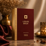 Soghaat French Avenue Liquid Brun Limited Edition perfume box in deep burgundy with gold accents on a marble surface.