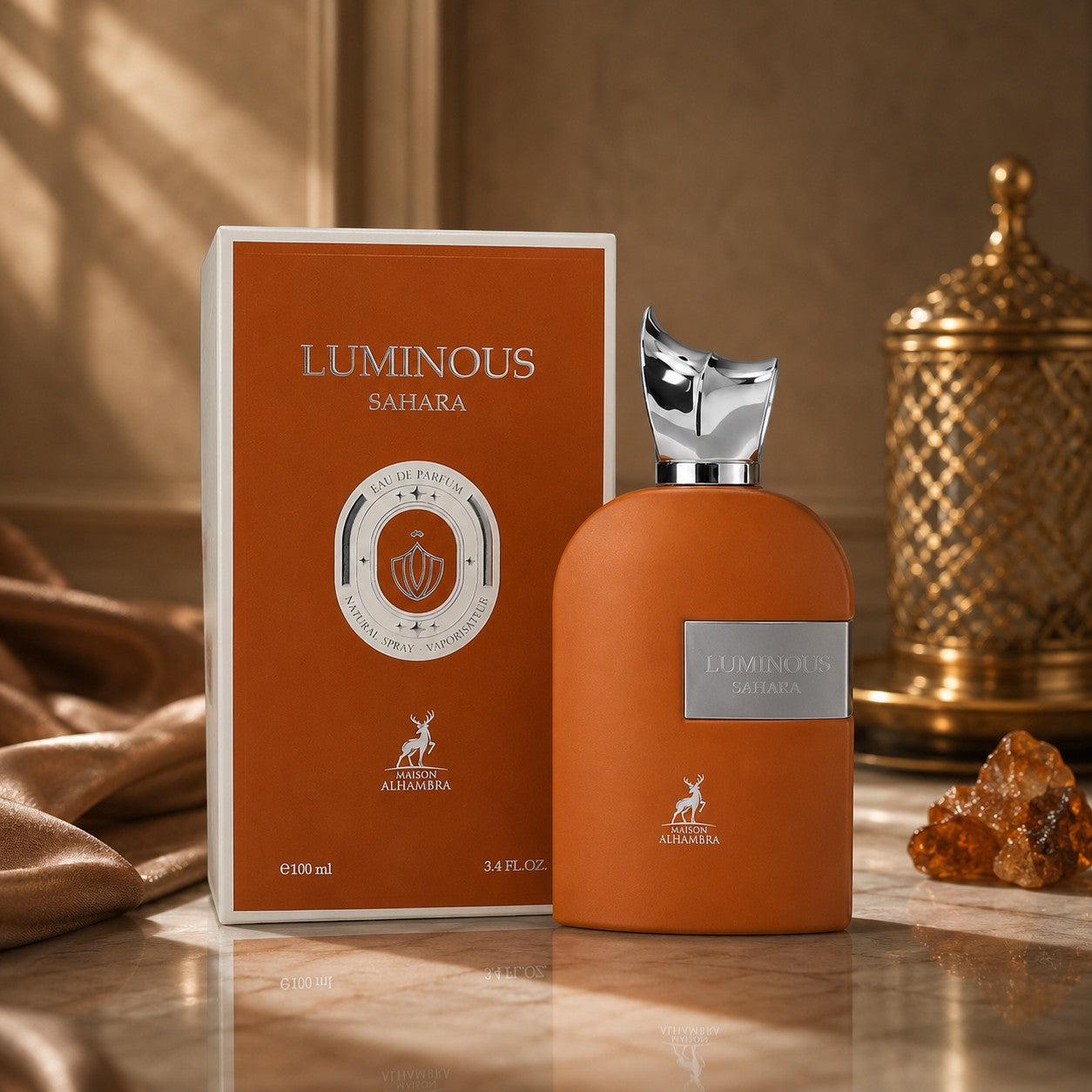 Soghaat Luminous Sahara Eau de Parfum by Maison Alhambra in a burnt orange bottle and box with silver accents.