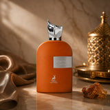 Soghaat Maison Alhambra Luminous Sahara unisex Eau de Parfum in an orange bottle with a metallic cap on a marble surface