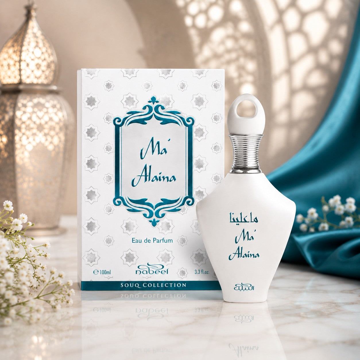 Soghaat Ma'Alaina Eau de Parfum by Nabeel in a white bottle with teal accents, displayed with its matching box.