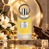 Soghaat Maison Alhambra Aurum Luxura 100ml Eau de Parfum bottle with gold liquid, floral accents, and woody elements.