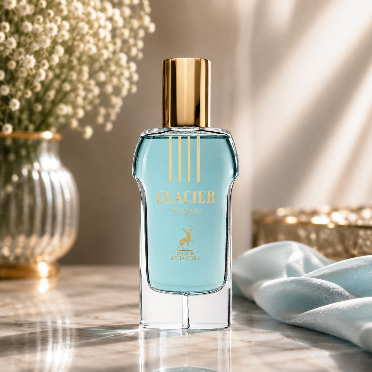 Soghaat Maison Alhambra Glacier Flora unisex Eau de Parfum in a blue glass bottle with a gold cap on a marble table.