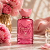 Soghaat Maison Alhambra Papillon D'Or Eau de Parfum in a pink glass bottle with butterfly motif and peony flowers.