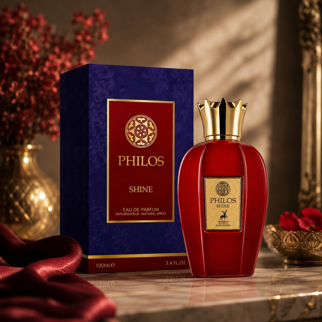 Soghaat Maison Alhambra Philos Shine 100ml Eau de Parfum bottle in red with gold cap next to its blue and red box.