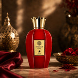 Soghaat Maison Alhambra Philos Shine Eau de Parfum in a vibrant red bottle with a gold crown cap on a marble surface.