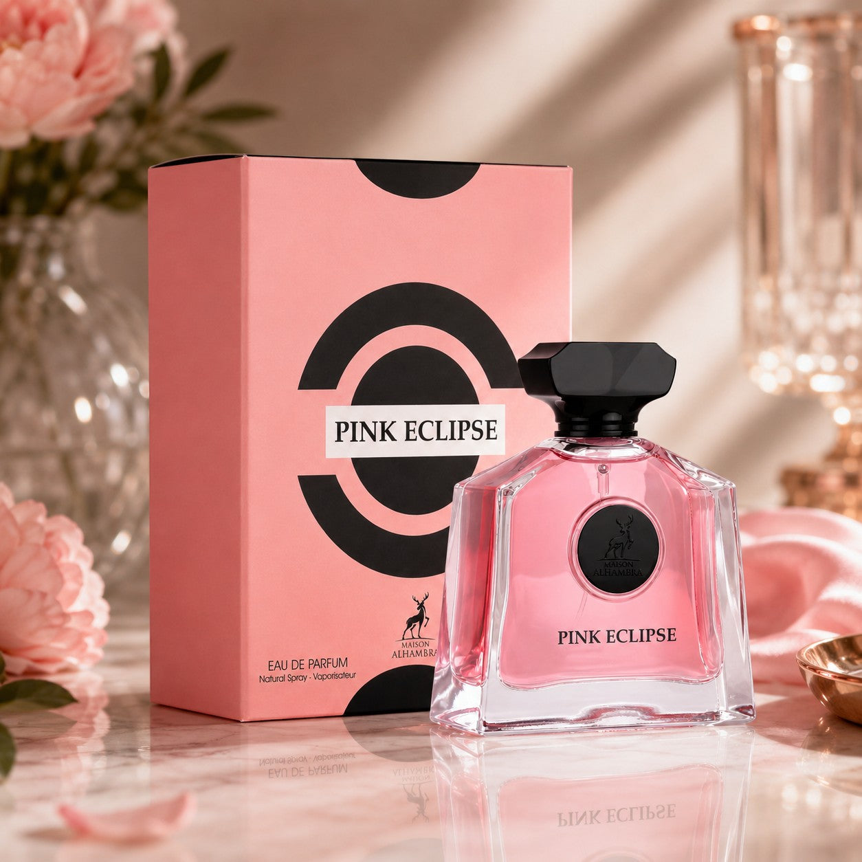 Soghaat Maison Alhambra Pink Eclipse Eau de Parfum bottle and pink box on a marble surface with floral accents.