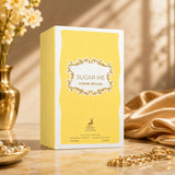 Soghaat Maison Alhambra Sugar Me Creme Brulee Eau de Parfum 100ml bottle in yellow and white packaging on a table.