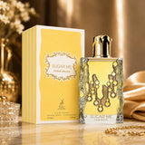 Soghaat Maison Alhambra Sugar Me Creme Brulee 100ml Eau de Parfum bottle and yellow box on a gold surface.