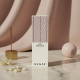 Soghaat Miss Arrogate Eau de Parfum bottle with a cream base and a pink and black patterned cap. Fresh woody aromatic scent.