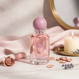 Soghaat Miss Laverne Eau de Parfum, a soft sweet musk fragrance for women with a pink hue, presented in a clear glass bottle with a lavender cap.