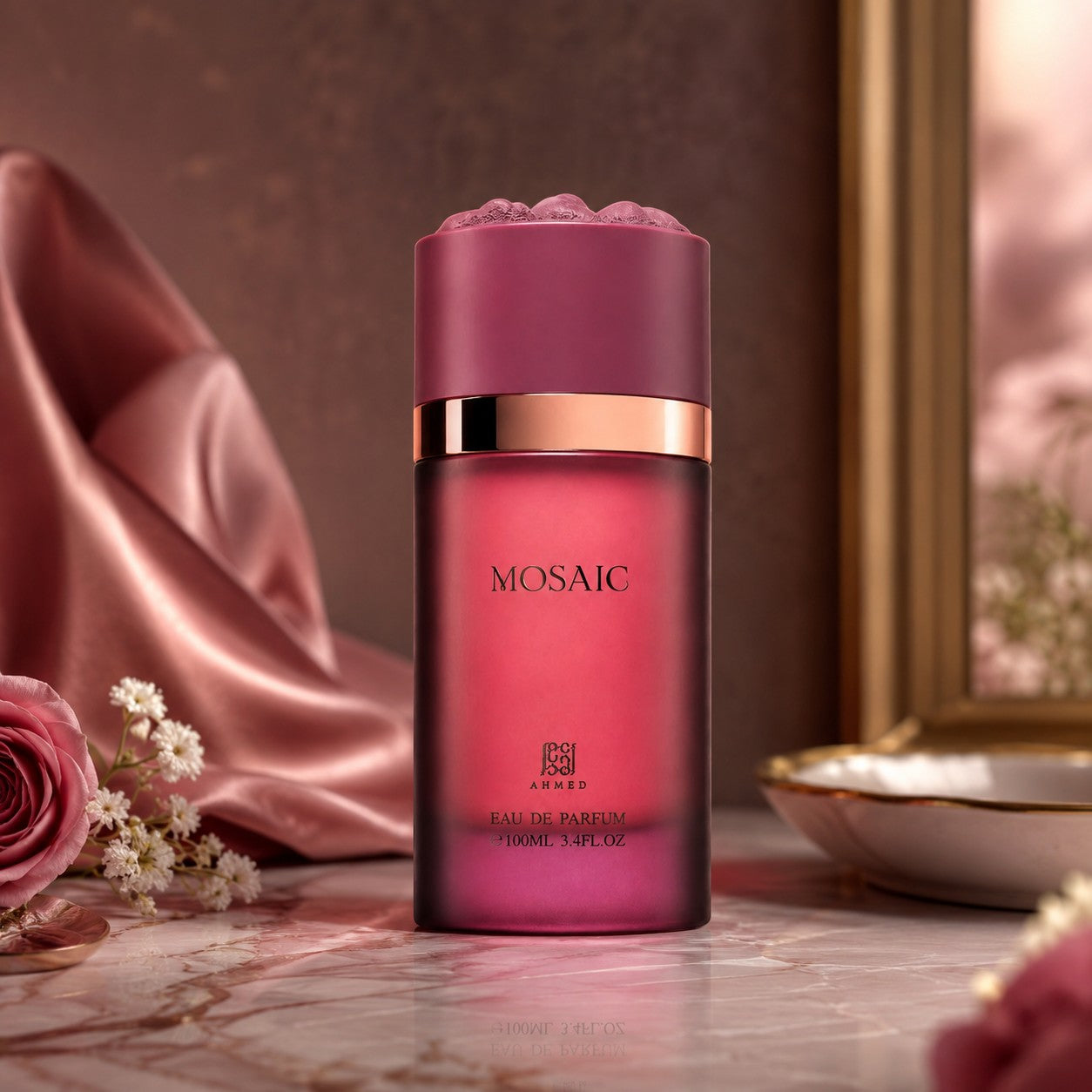 Soghaat Mosaic 100ml Extrait de Parfum bottle in deep pink glass with a textured cap, set on a marble surface.