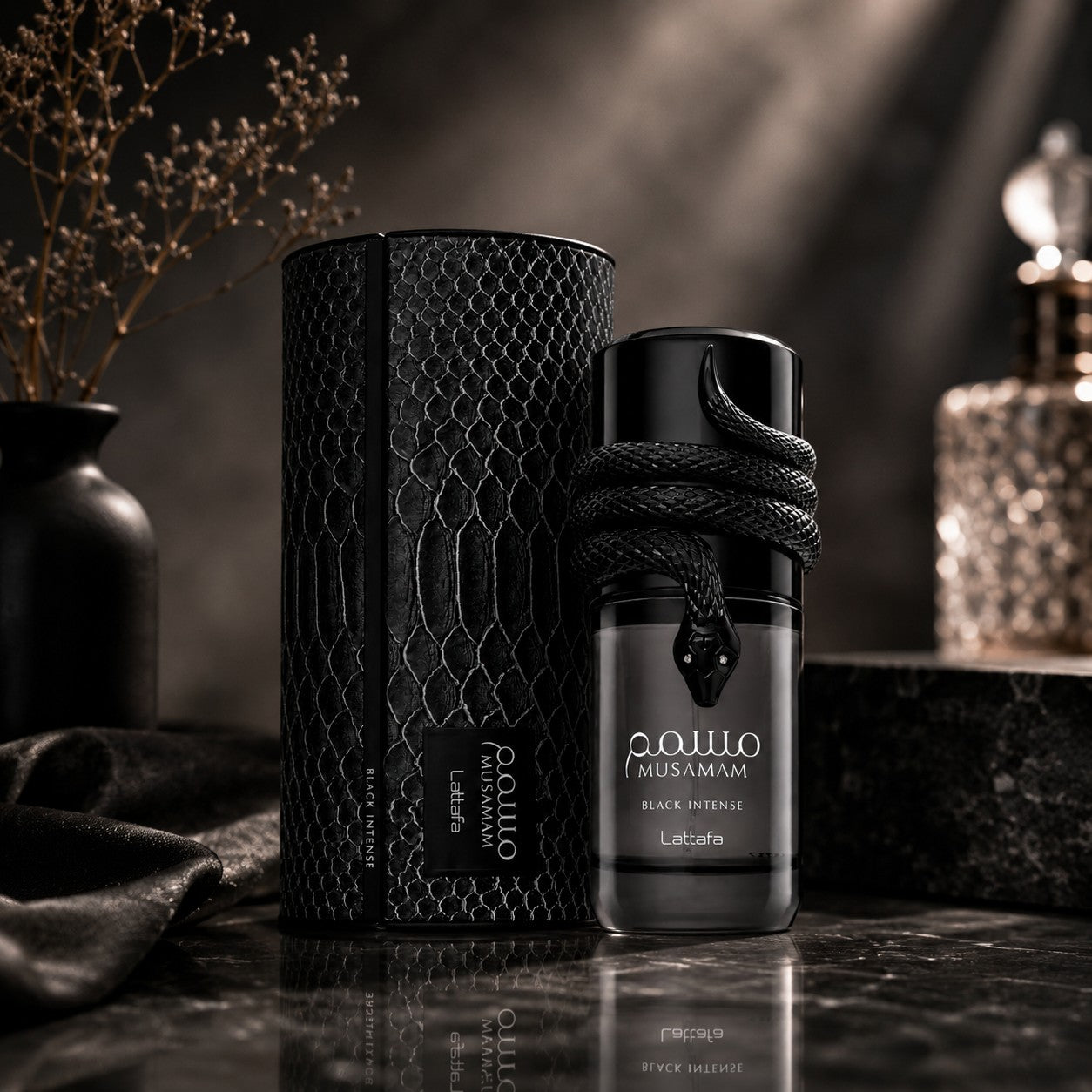 Soghaat Lattafa Musamam Black Intense perfume bottle with a snake design and matching textured box on a dark surface.