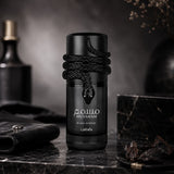 Soghaat Lattafa Musamam Black Intense Eau de Parfum bottle featuring a coiled black snake design on a marble surface.