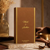Soghaat Musk And Leather 100ml Eau de Parfum box in brown with gold lettering, displayed on a stone surface.