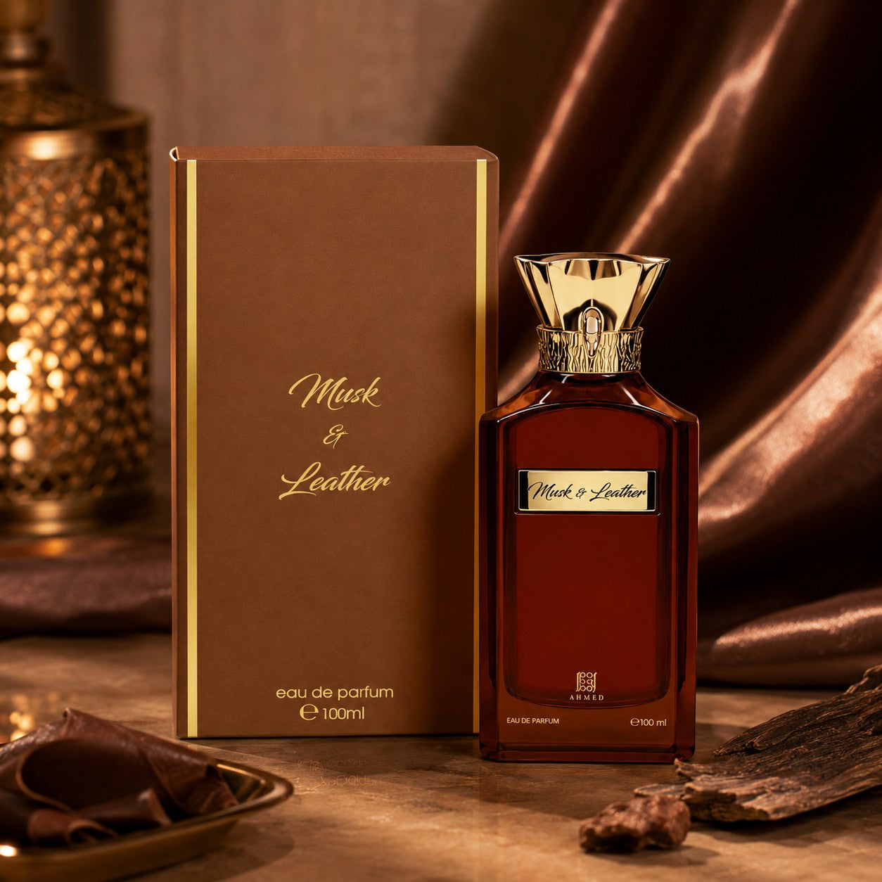 Soghaat Musk And Leather 100ml Eau de Parfum bottle and box with gold accents on a warm, elegant brown background.