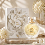 Soghaat Ahmed Al Maghribi Musk & Roses Extrait de Parfum bottle and floral gift box on a marble surface with white roses.