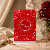 Soghaat Nabeel Dan Dana 100ml Eau de Parfum in a vibrant red box with musical note motifs, displayed on a marble surface.