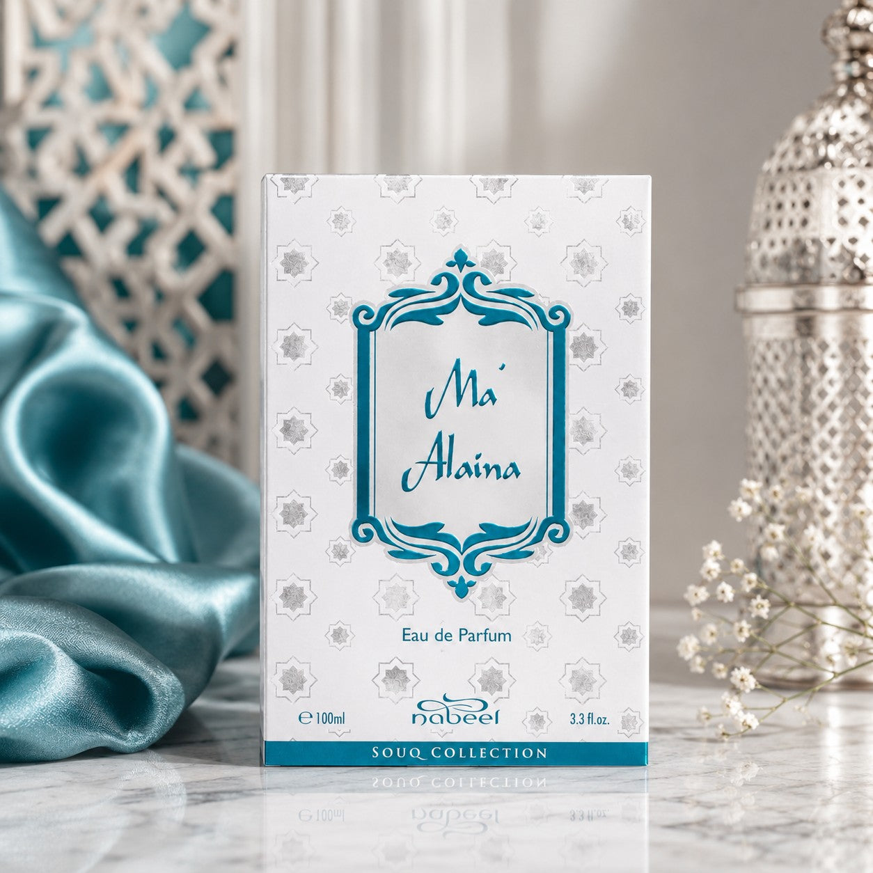 Soghaat Nabeel Ma'Alaina 100ml Eau de Parfum box with teal and silver geometric patterns on a marble surface.