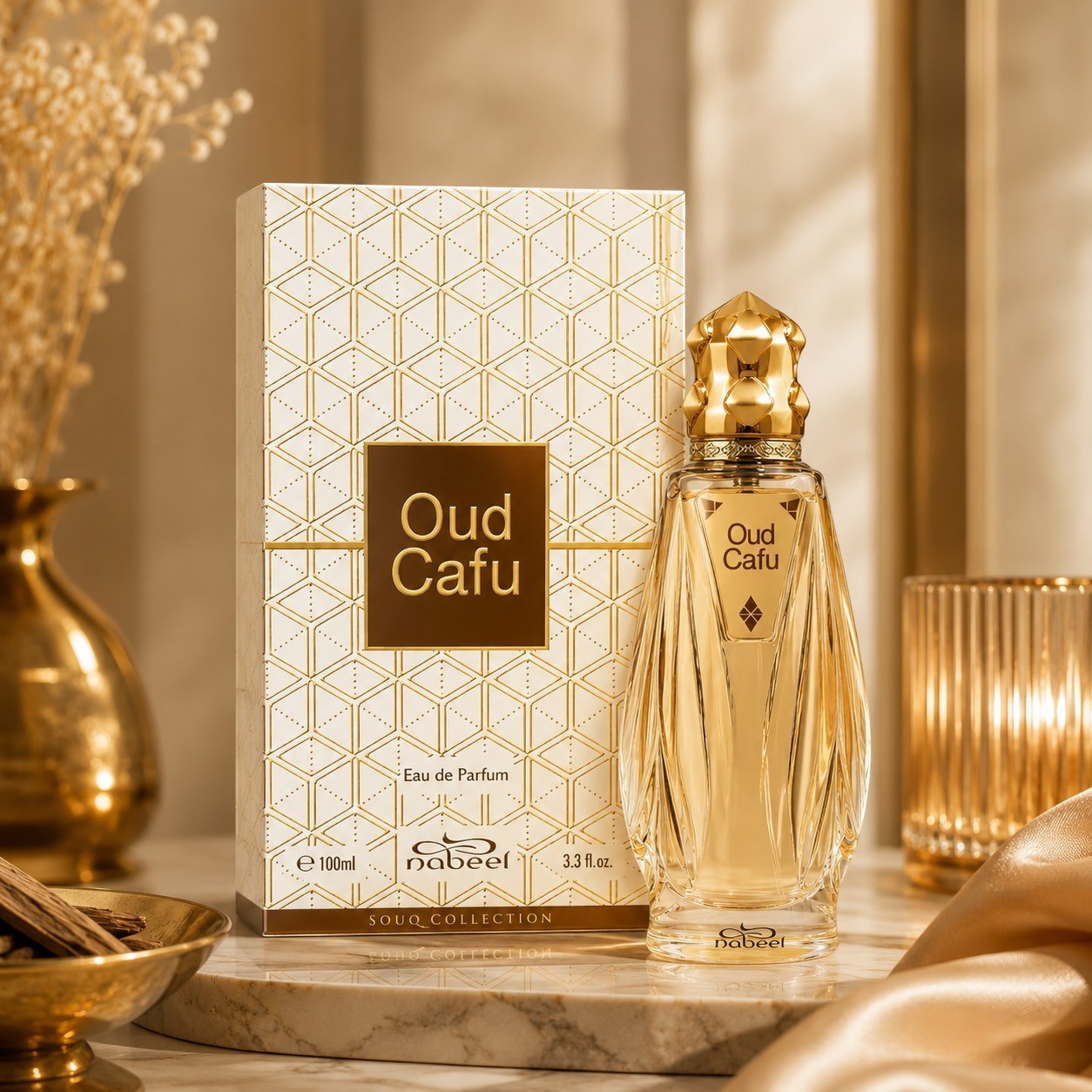 Soghaat Nabeel Oud Cafu 100ml Eau de Parfum bottle and patterned box on a marble surface with gold accents