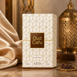 Soghaat Nabeel Oud Cafu 100ml Eau de Parfum box with geometric gold pattern, displayed with a golden lantern and oud chips.