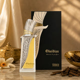 Soghaat Obsidian Extrait de Parfum, a fresh woody aromatic fragrance in a decorative silver and gold bottle with yellow liquid.