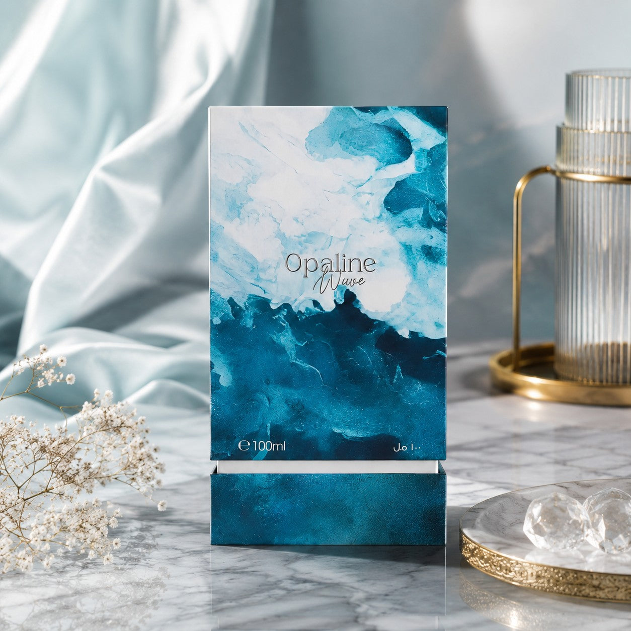 Soghaat Opaline Wave 100ml Extrait de Parfum box with blue and white abstract wave design on a marble surface.