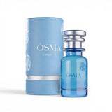 Soghaat Osma Cotton' C Eau de Parfum bottle and cylindrical box, both light blue with white floral accents.
