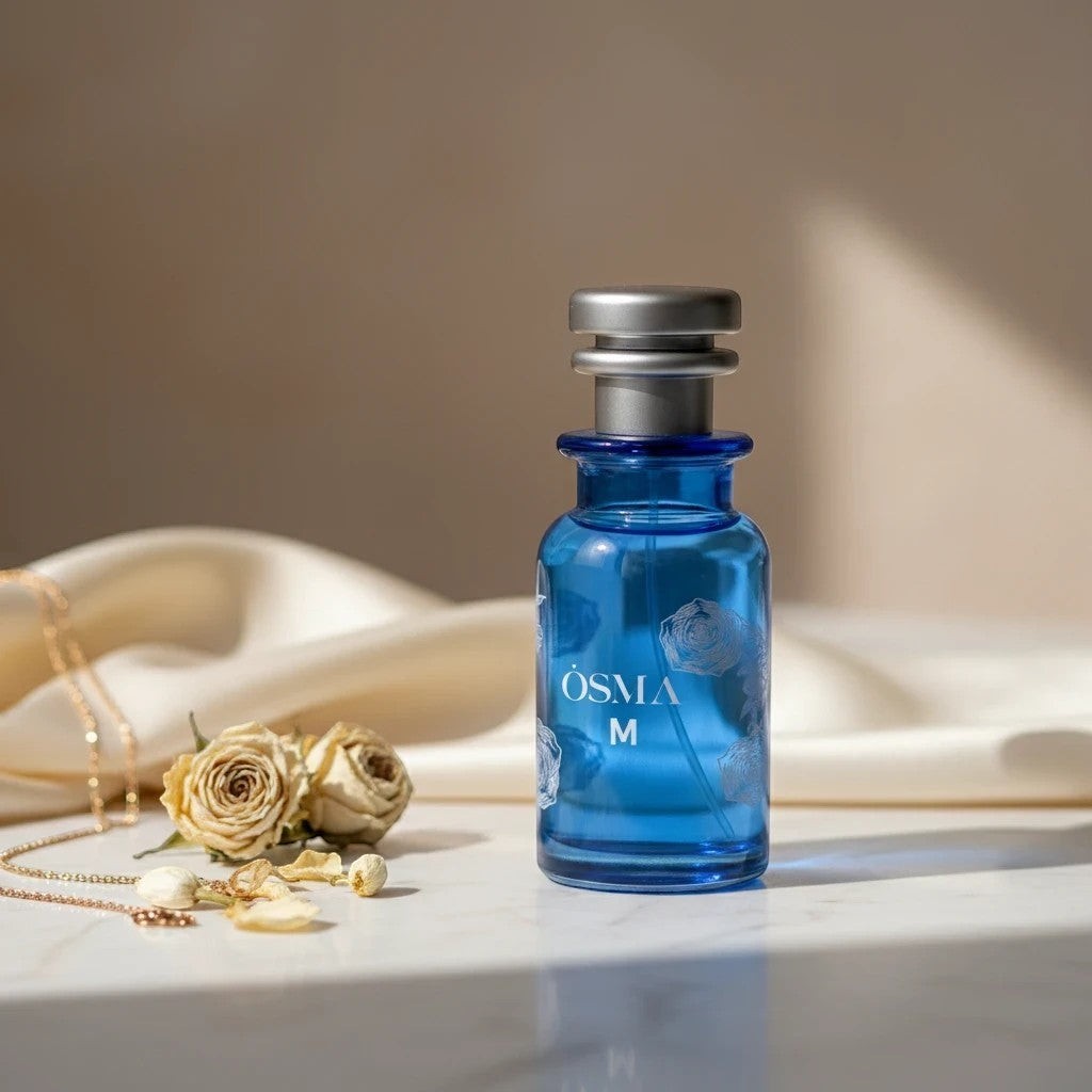 Soghaat Osma M Eau de Parfum, a sweet gourmand fragrance in a blue glass bottle with silver accents.