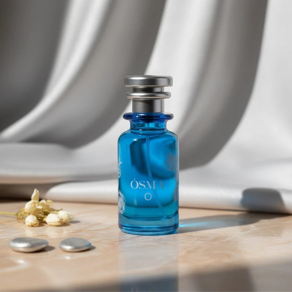 Soghaat Osma O Eau de Parfum, a fresh clean musk fragrance in a blue glass bottle with silver cap. Notes of pear, tobacco, and musk.