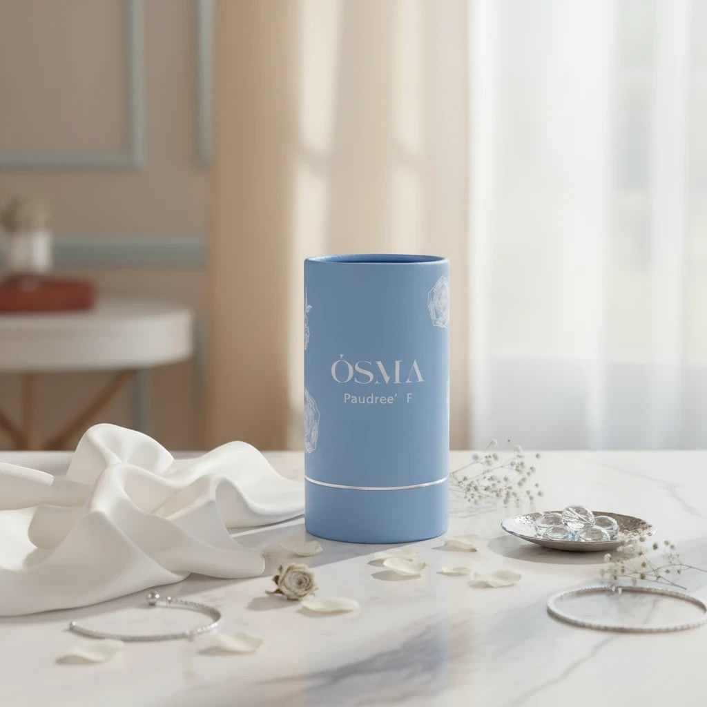 Soghaat Osma Paudree F Eau de Parfum, a soft sweet musk fragrance with jasmine, rose, and musk notes in a light blue cylindrical bottle.